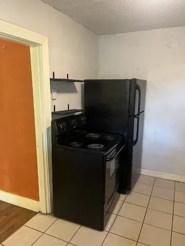 a kitchen with a stove and a refrigerator