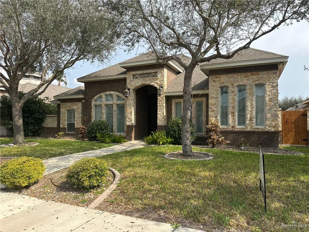 10312 North 25th Street McAllen, TX 78504 - Photo 2 of 2 a front view of a house with garden