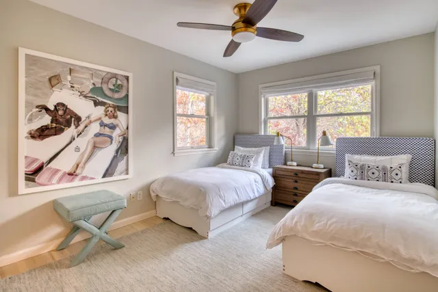 a bedroom with two beds and a window