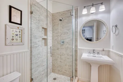 a bathroom with a sink a mirror and a shower