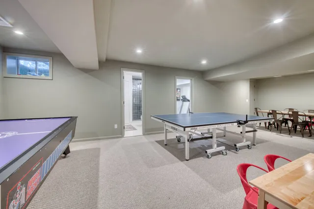a living room with furniture a rug and gym equipment