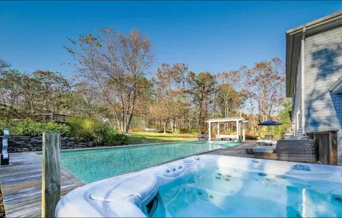 a view of a swimming pool with a yard