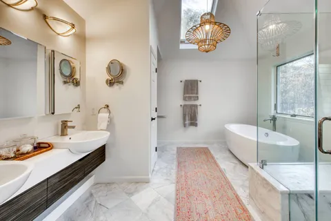 a spacious bathroom with a double vanity sink a toilet and mirror