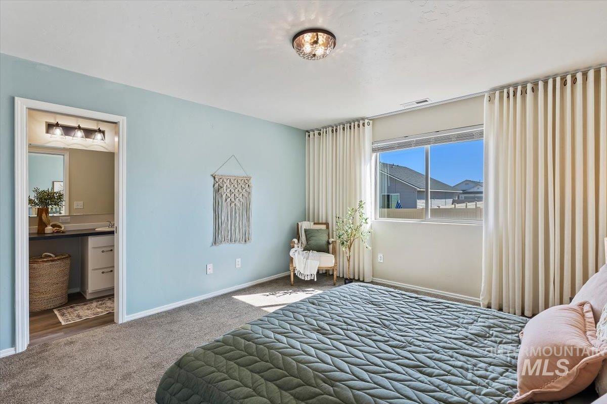 12781 Ashfield Street Caldwell, ID 83607 - Photo 13 of 30 Carpeted bedroom featuring baseboards and ensuite bathroom