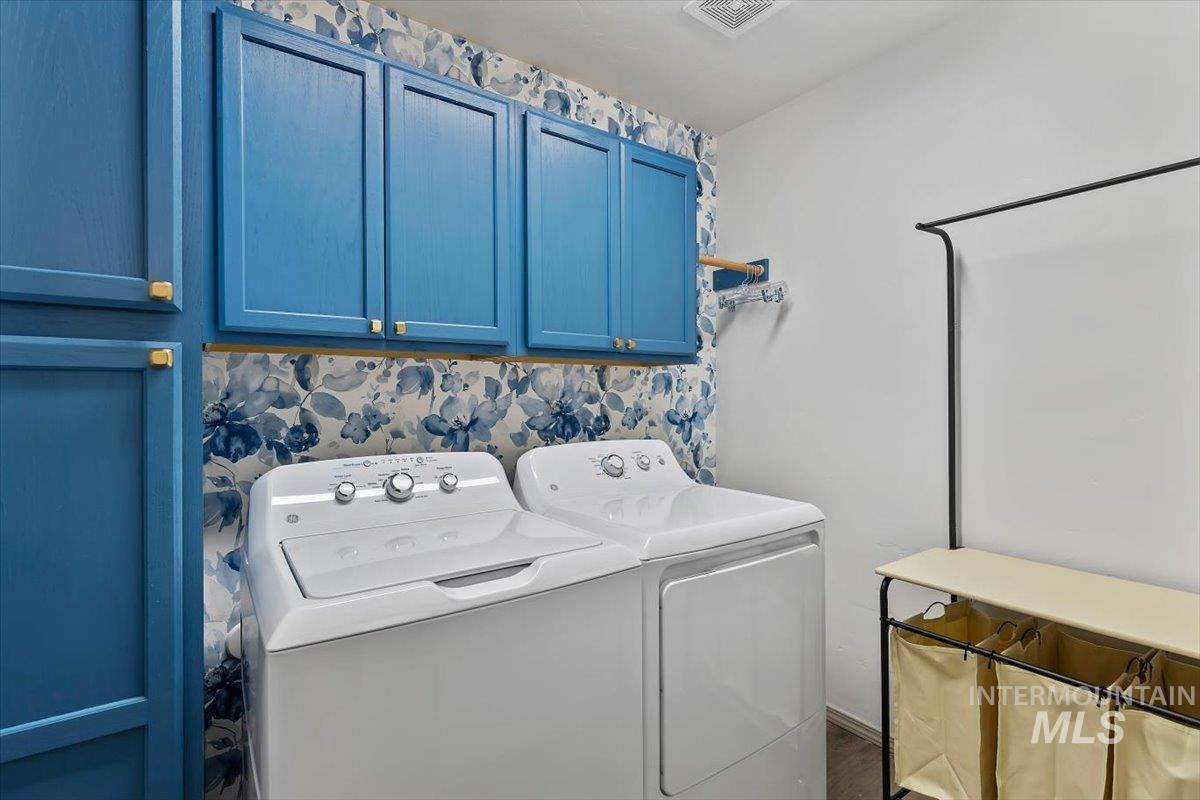 12781 Ashfield Street Caldwell, ID 83607 - Photo 17 of 30 Laundry room featuring separate washer and dryer and cabinet space