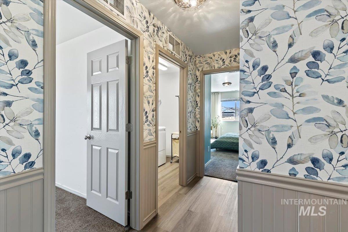 12781 Ashfield Street Caldwell, ID 83607 - Photo 18 of 30 Corridor featuring wallpapered walls and wainscoting
