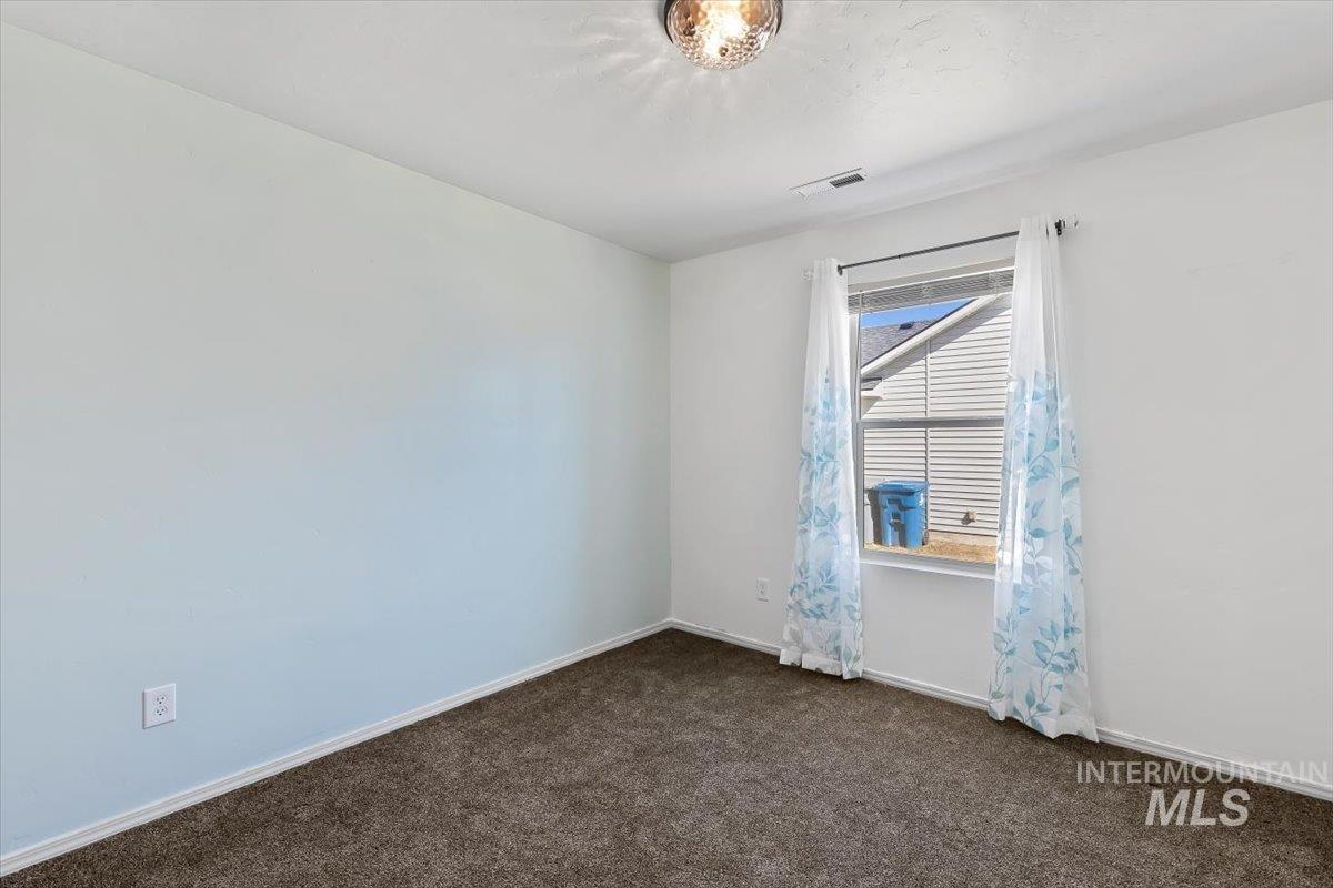 12781 Ashfield Street Caldwell, ID 83607 - Photo 23 of 30 Spare room with baseboards and dark carpet