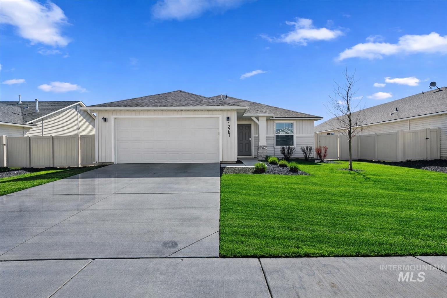 12781 Ashfield Street Caldwell, ID 83607 - Photo 26 of 30 Ranch-style house featuring an attached garage, driveway, roof with shingles, and board and batten siding