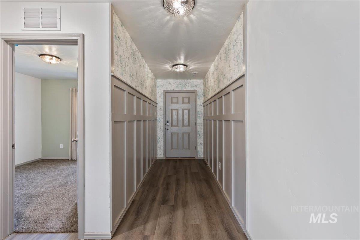 12781 Ashfield Street Caldwell, ID 83607 - Photo 5 of 30 Hall featuring wallpapered walls and wood finished floors