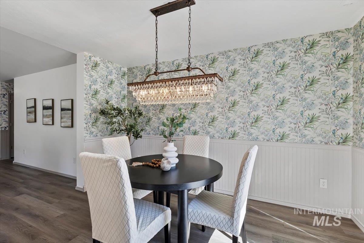 12781 Ashfield Street Caldwell, ID 83607 - Photo 8 of 30 Dining space featuring wainscoting, wallpapered walls, and dark wood-type flooring