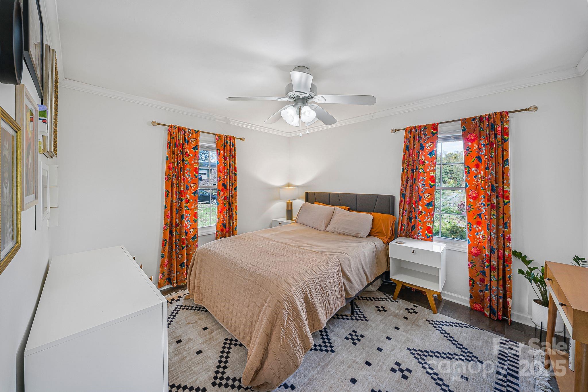 16 Woodfield Road Arden, NC 28704 - Photo 20 of 41 a bedroom with a bed and a chandelier