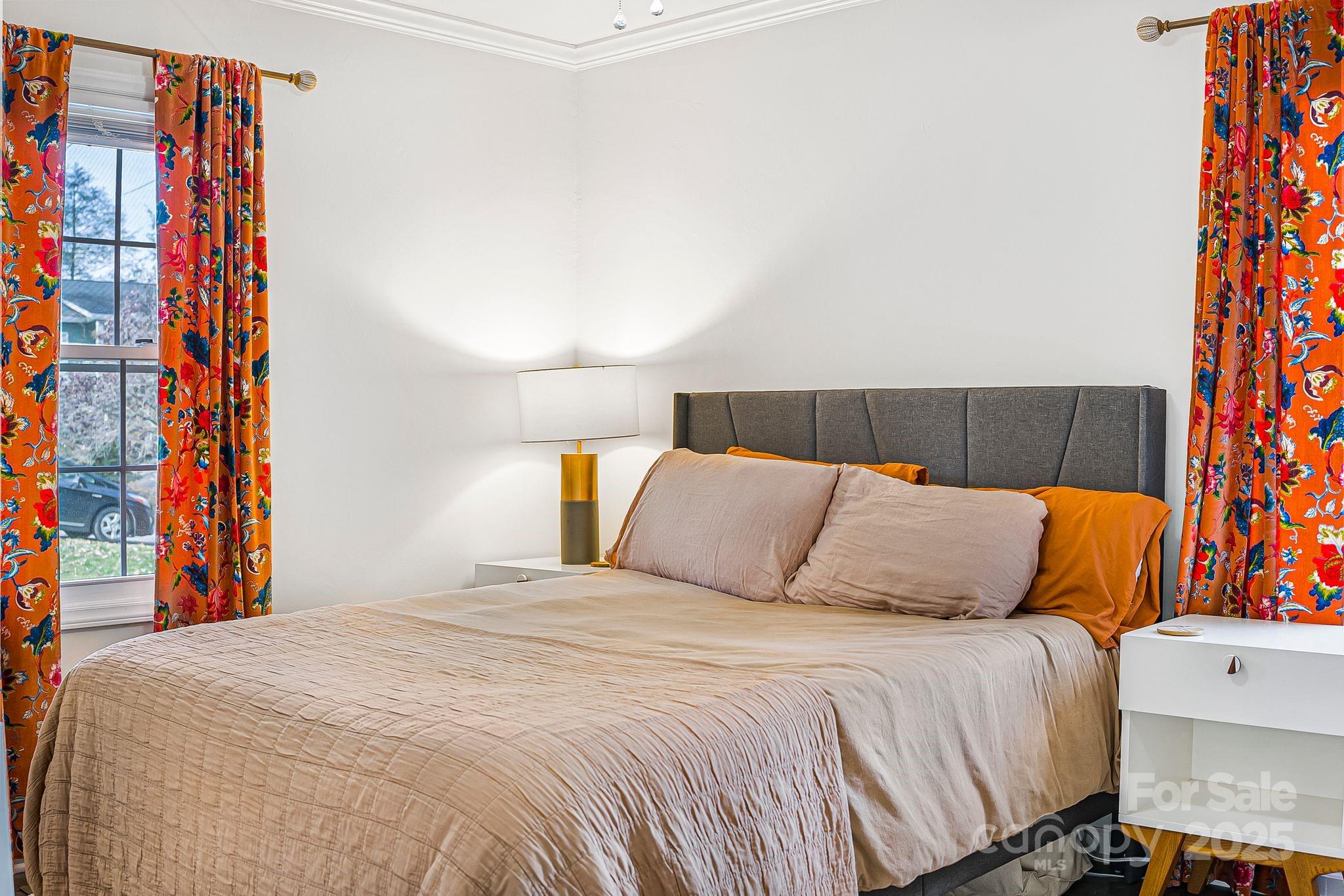 16 Woodfield Road Arden, NC 28704 - Photo 22 of 41 a bedroom with a bed and lamp on the dresser