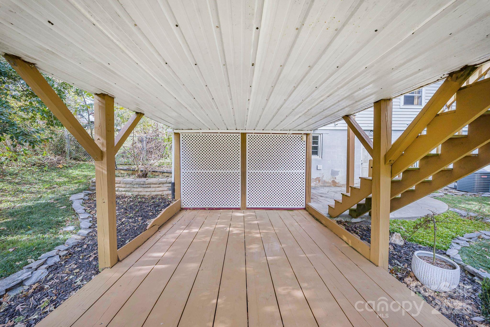 16 Woodfield Road Arden, NC 28704 - Photo 35 of 41 a view of a room with wooden floor and iron stairs