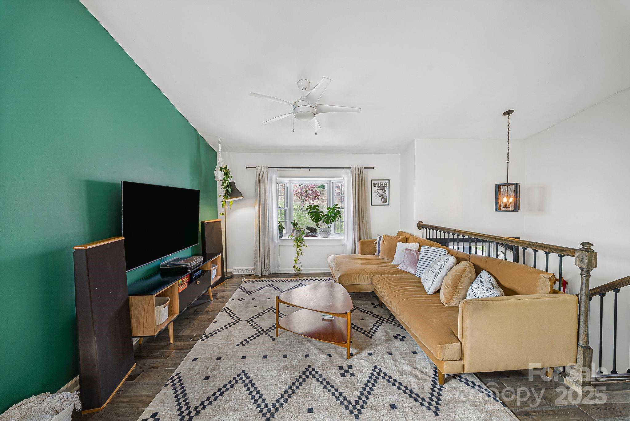 16 Woodfield Road Arden, NC 28704 - Photo 6 of 41 a living room with furniture and a flat screen tv