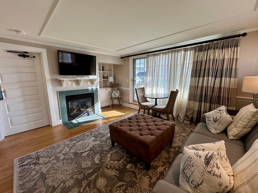 38 North Water Street, Unit R2 Edgartown, MA 02539 - Photo 13 of 38 Living room with propane fireplace and sliders leading to the private deck facing Edgartown Harbor.