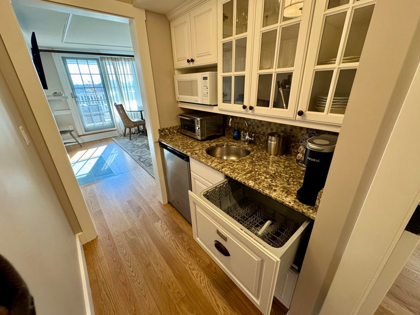 38 North Water Street, Unit R2 Edgartown, MA 02539 - Photo 19 of 38 Kitchenette includes under-counter refrigerator, microwave, convection/toaster oven, dishwasher, coffee maker and fully stocked cabinets with glasses, dishes and serve ware .