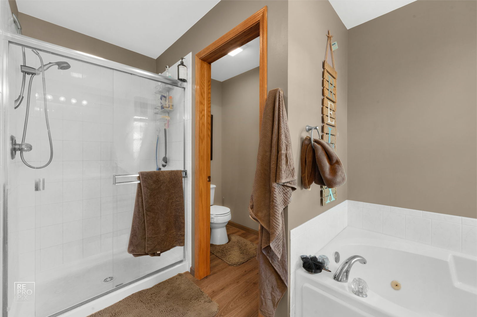29 Bay Drive Itasca, IL 60143 - Photo 20 of 28 a bathroom with a tub a mirror and a shower