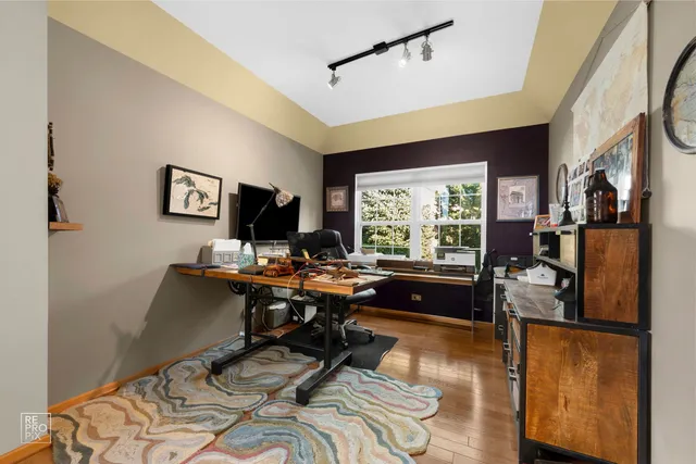 a living room with furniture a window and a flat screen tv