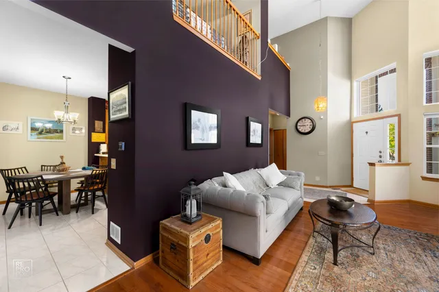 a living room with furniture dining area and a window