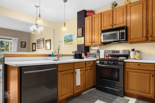 a kitchen with granite countertop a sink stainless steel appliances and cabinets