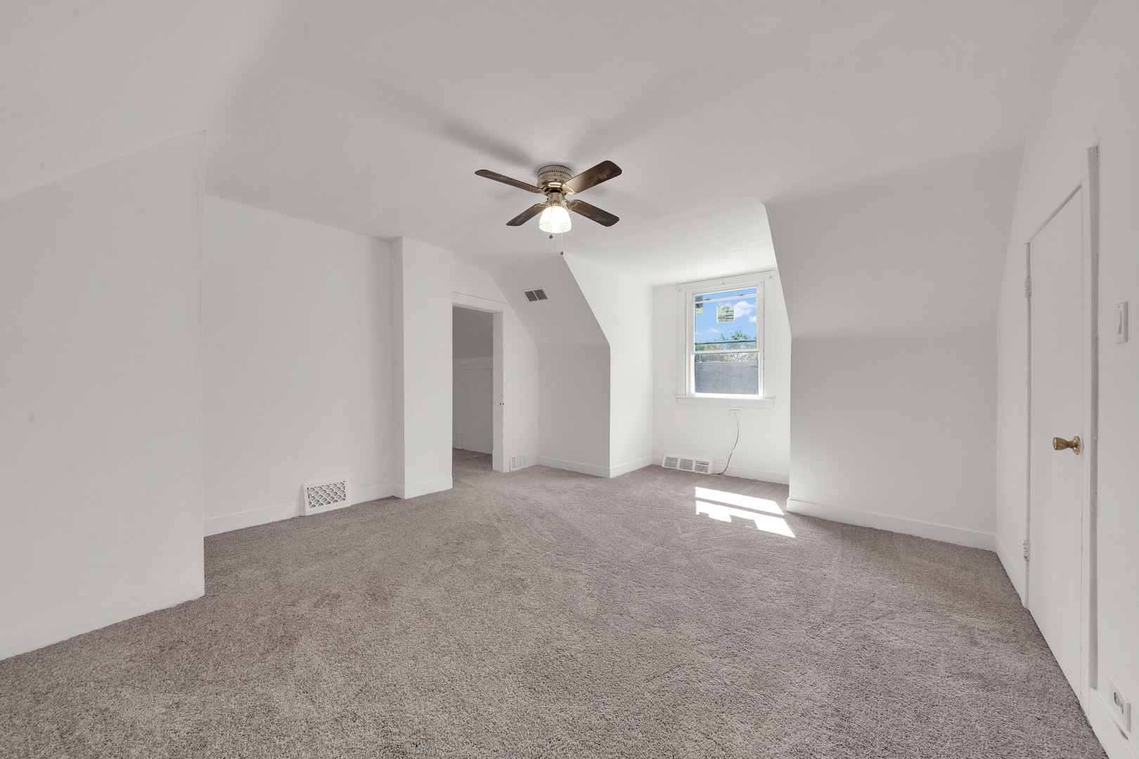 11548 South State Street Chicago, IL 60628 - Photo 15 of 22 an empty room with fan and windows