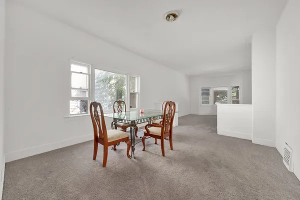 a kitchen with stainless steel appliances white cabinets and a refrigerator