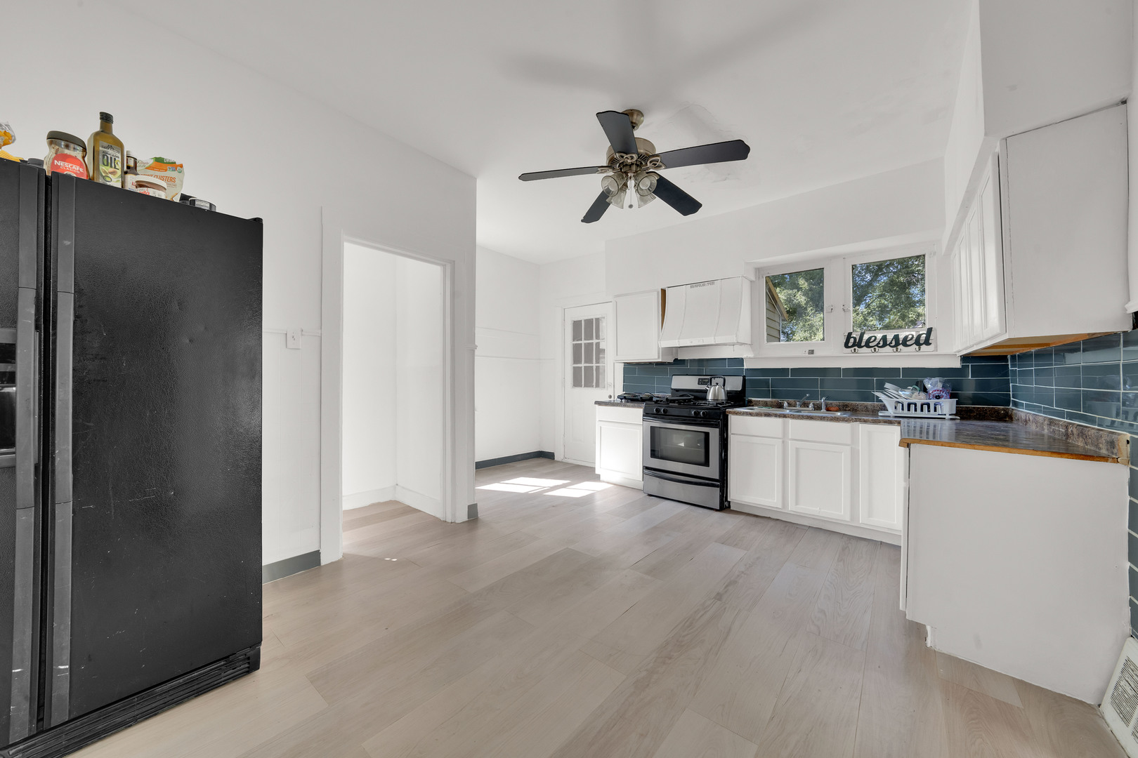 11548 South State Street Chicago, IL 60628 - Photo 7 of 22 a kitchen with stainless steel appliances white cabinets and a refrigerator