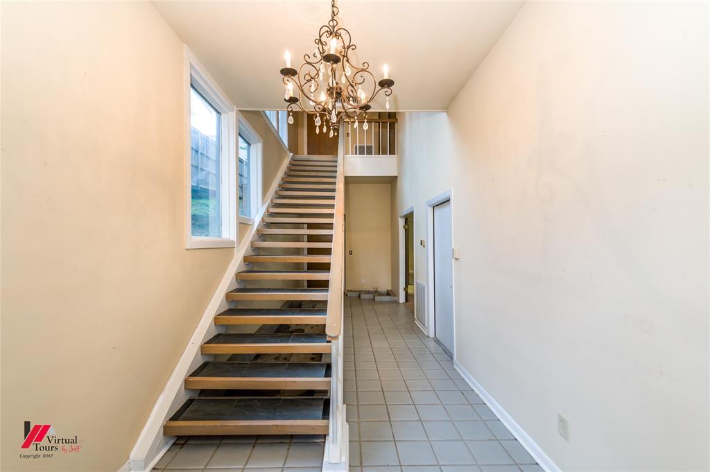 300 Pierremont Road, Unit 40 Shreveport, LA 71106 - Photo 5 of 34 Two-story entryway with a decorative chandelier and light-toned wall finishes
