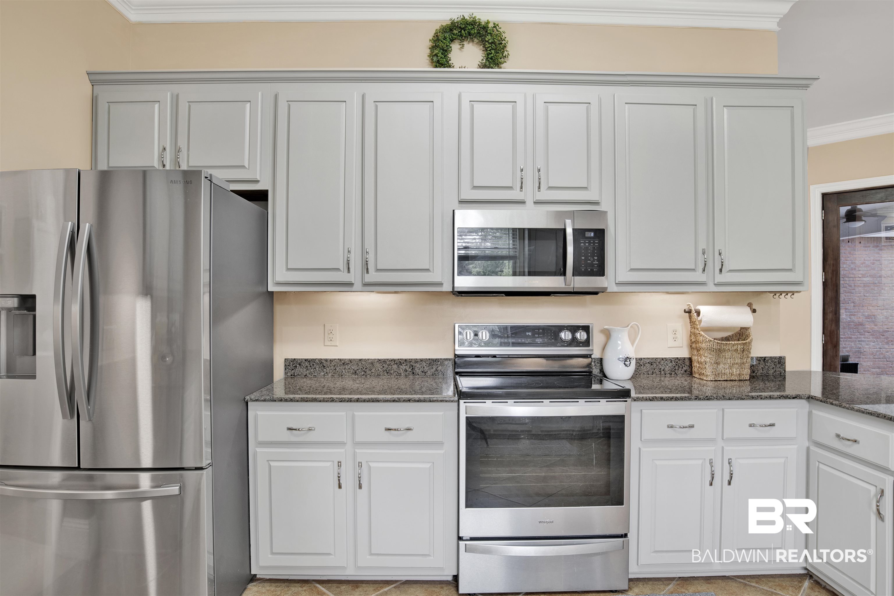 4340 Hamilton Oaks Lane Mobile, AL 36695 - Photo 17 of 51 Kitchen with stainless steel appliances, dark stone countertops, white cabinets, and crown molding