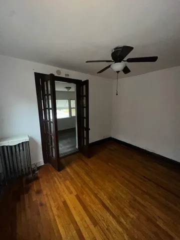 a view of an empty room with a dresser