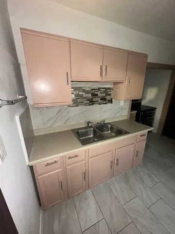a kitchen with white cabinets and white appliances