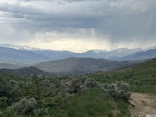 a view of a house with a mountain in the background