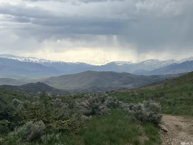 a view of a house with a mountain in the background