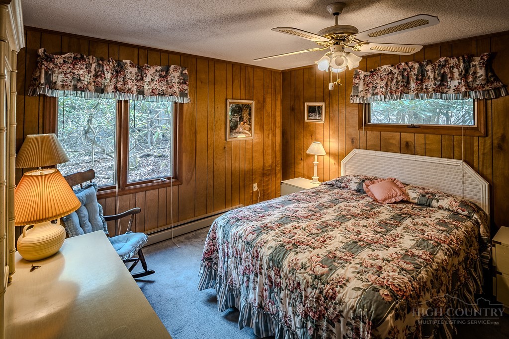 107-109 Shagbark Road Beech Mountain, NC 28604 - Photo 23 of 45 a bedroom with a bed and wooden floor