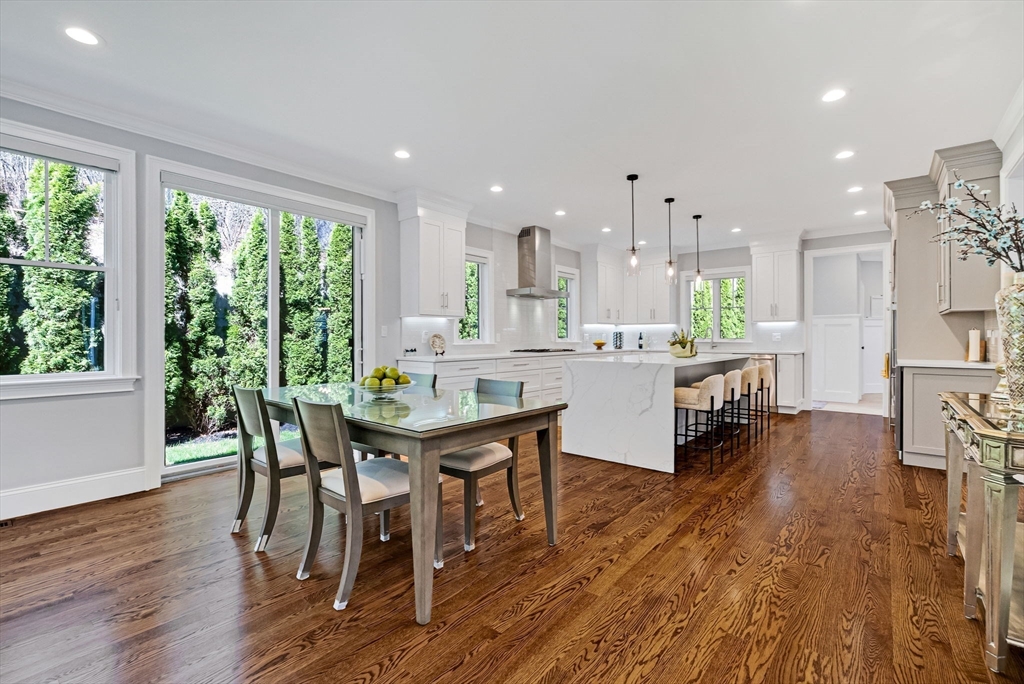 17 Sunrise Terrace Needham, MA 02492 - Photo 6 of 42 a dining hall with stainless steel appliances a dining table wooden floor and a large window
