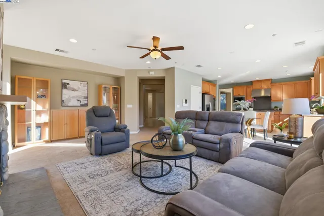 a bedroom with a bed and a ceiling fan