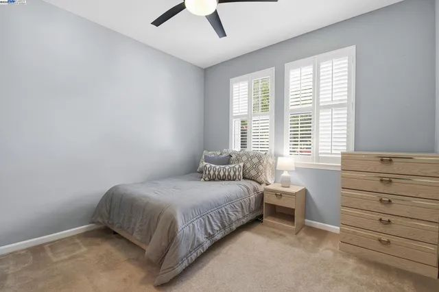 a bedroom with bed and a window