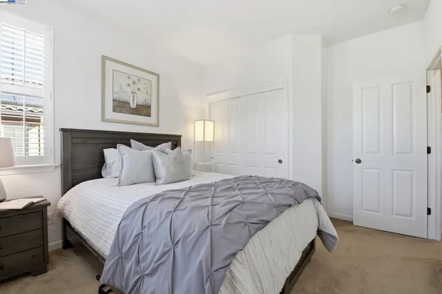 a bedroom with a bed and a closet