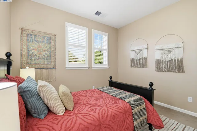 a bedroom with a bed and a flat screen television