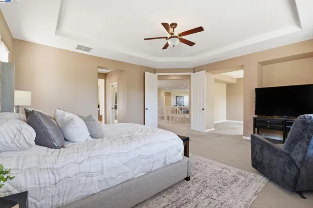 a bathroom with double vanity sink a toilet and a mirror