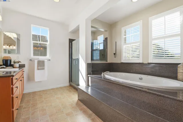 a view of a backyard with swimming pool and sitting area