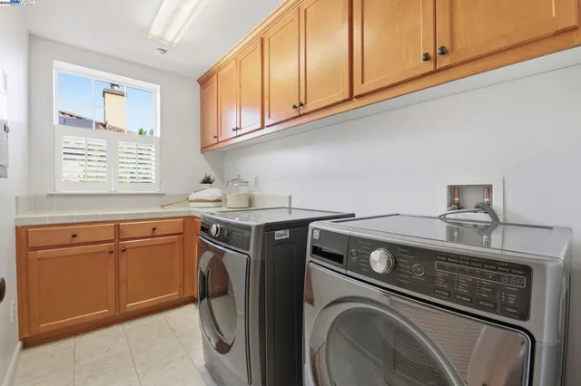 a view of a house with swimming pool and sitting area