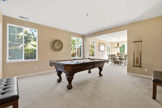 a kitchen with stainless steel appliances granite countertop a sink a stove and a refrigerator