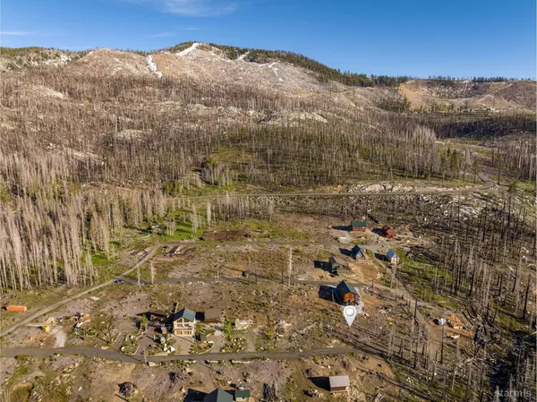 a view of a dry yard with mountains