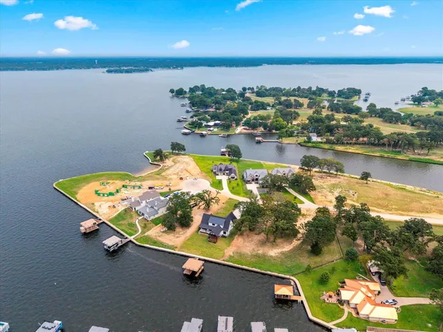 an aerial view of a residential houses with outdoor space and swimming pool