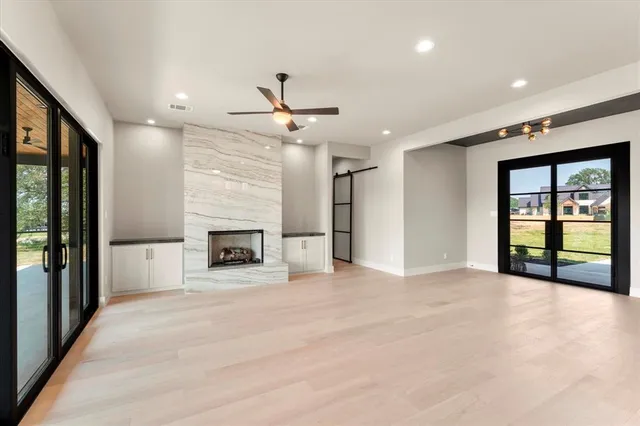 a view of an empty room with a fireplace and a window