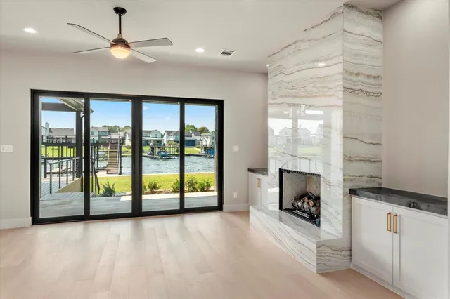 a view of an empty room with a fireplace and a window