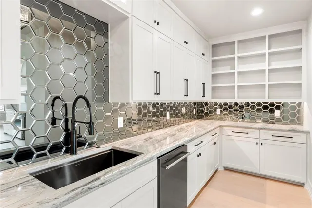 a kitchen with granite countertop white cabinets and appliances