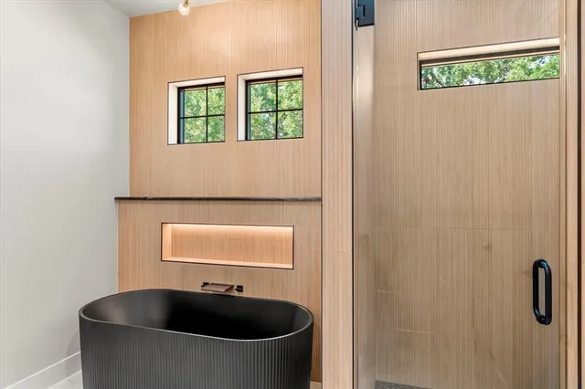 a bathroom with a tub and a window