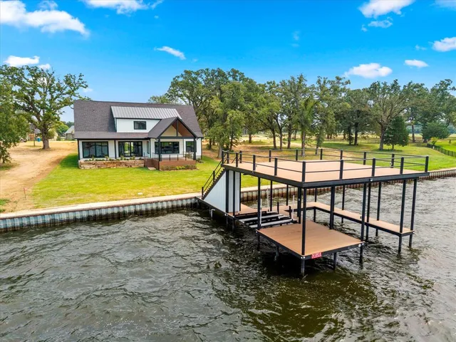 a view of a swimming pool with a garden and trees